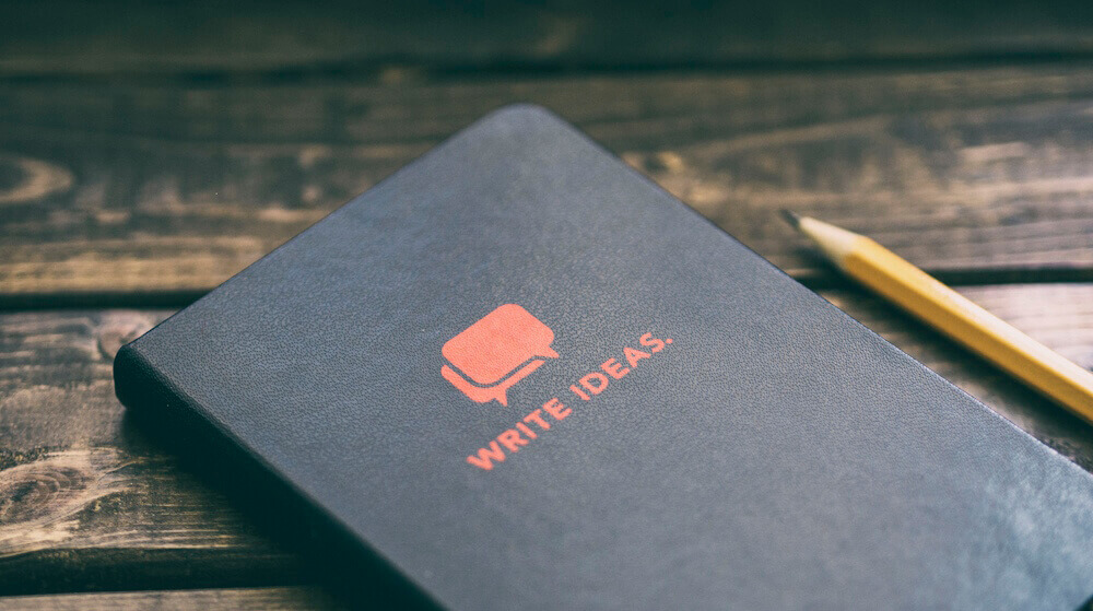 Notebook with the title Write Ideas. Photo by Aaron Burden on Unsplash used with permission